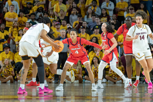 ASU Gabby Elliott deciding which side to drive to basket as UofA