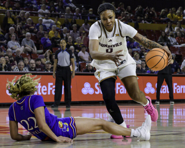 ASU's Gabby Elliott dribbles past Kansas Sania Copeland after she lost her footing.