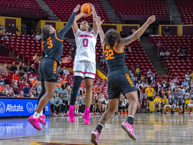 ASU Gabby Elliott pulls up with a jumper between two Oklahoma State defenders Micah Gray and Stailee Heard